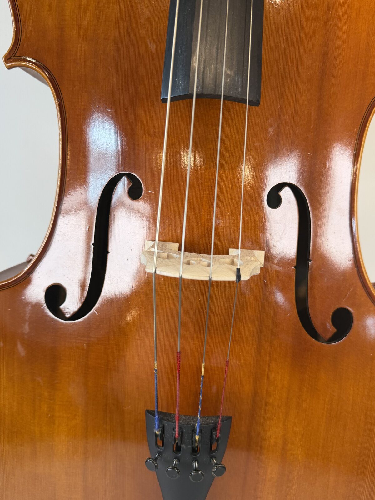 Close-up of the fitted, standing bridge and strings
